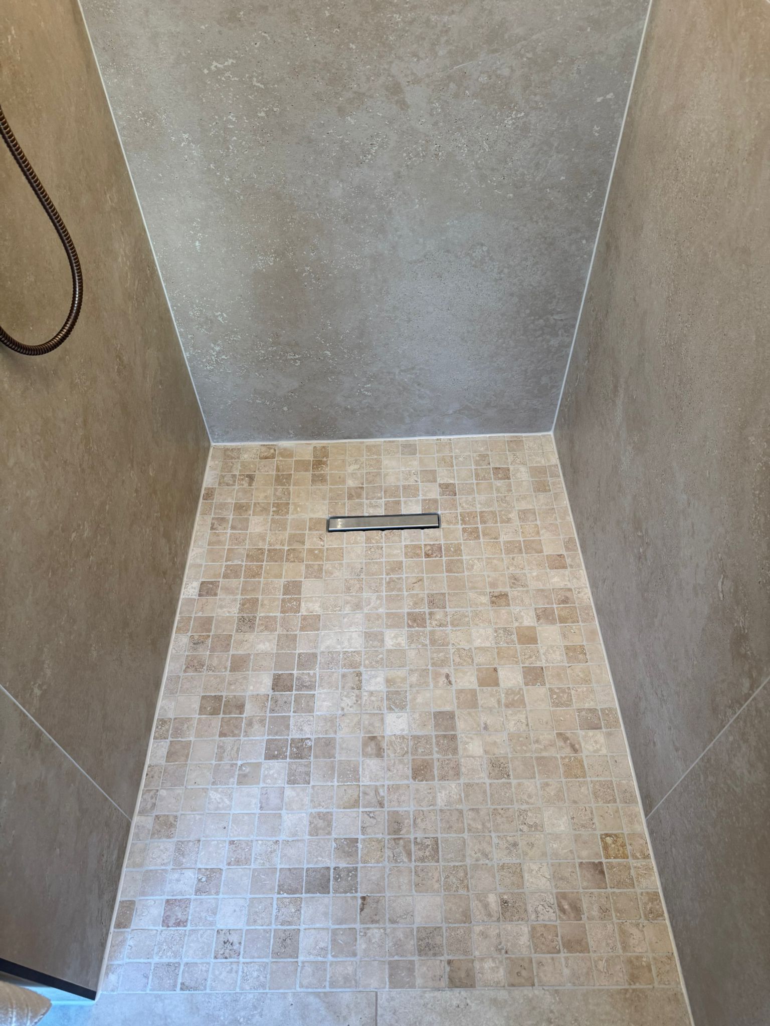 Luxury wet room installation with tiled shower floor and linear drain by MDS NE
