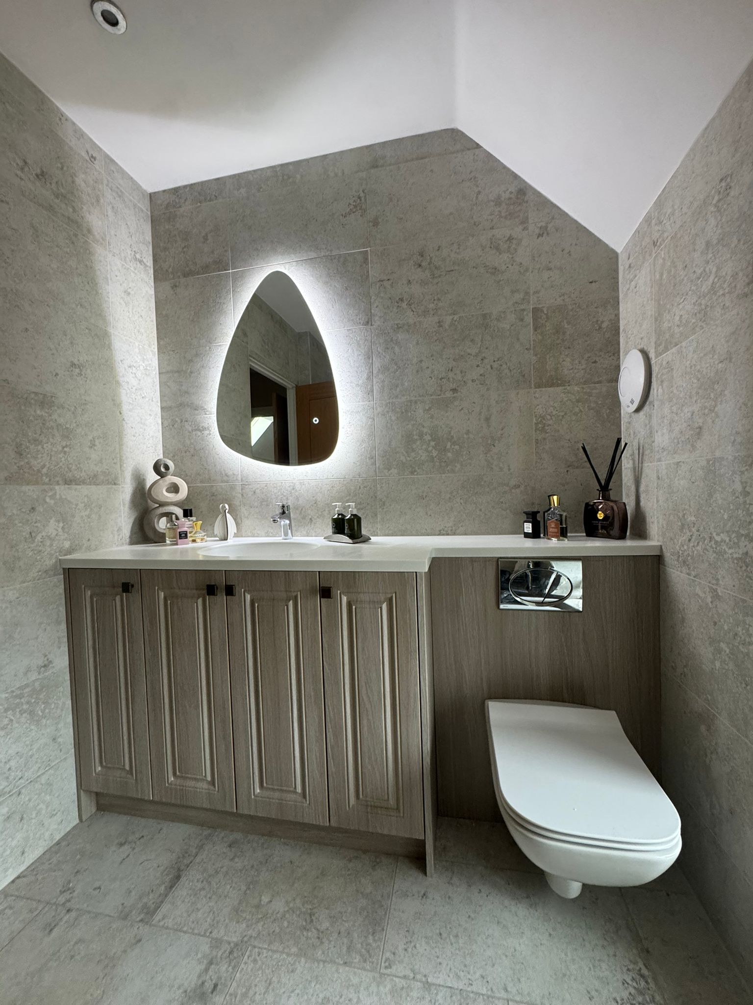 Luxury bathroom installation with fitted vanity unit, backlit mirror and concealed WC by MDS NE