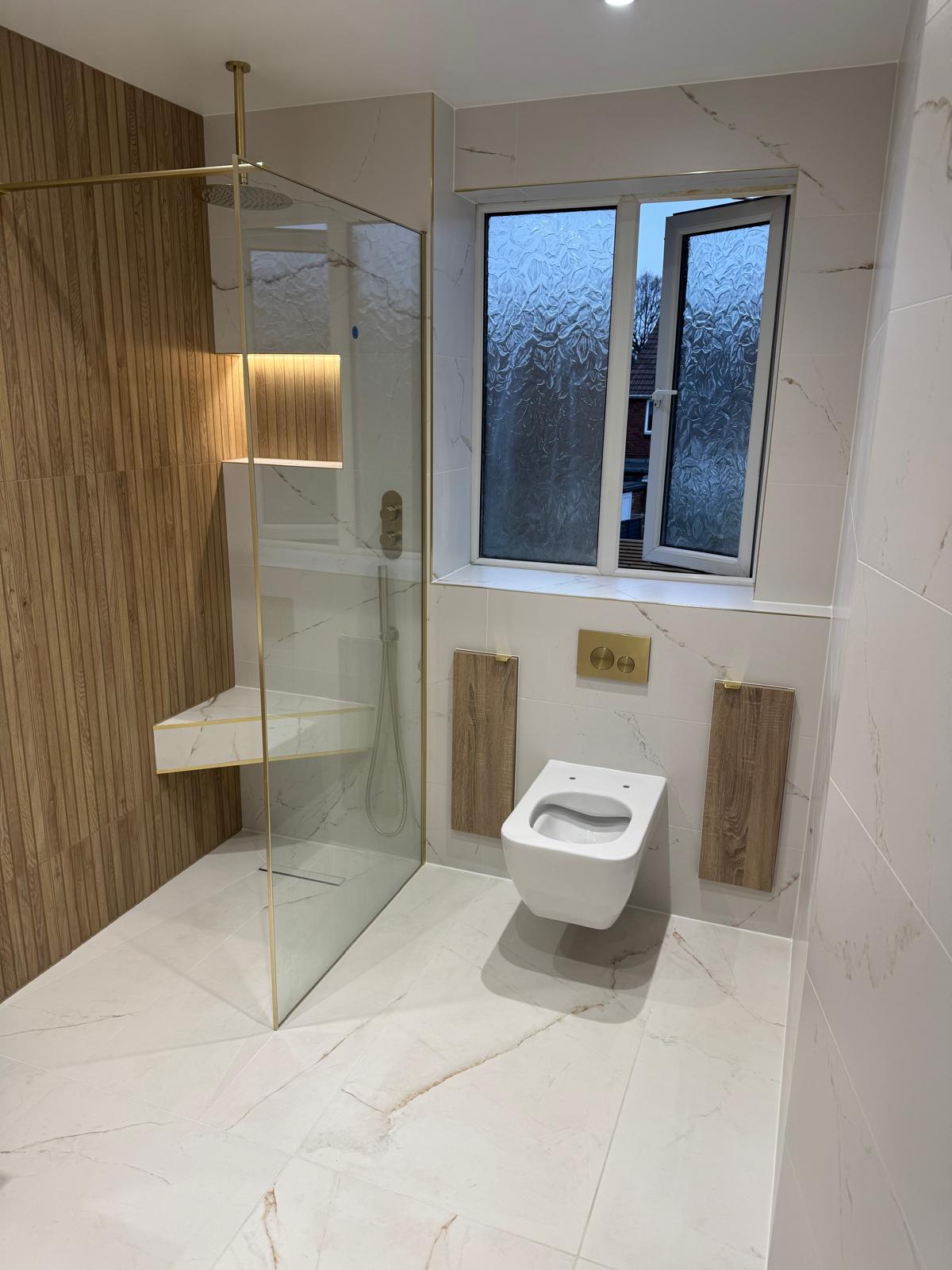 Luxury bathroom installation with walk-in shower and wall-hung toilet by MDS NE